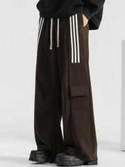 Men's brown loose-fit sweatpants with white side stripes and cargo pockets.