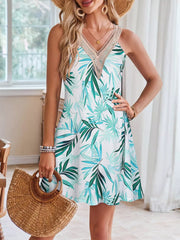 A-line dress with tropical leaf print and crochet trim neckline.