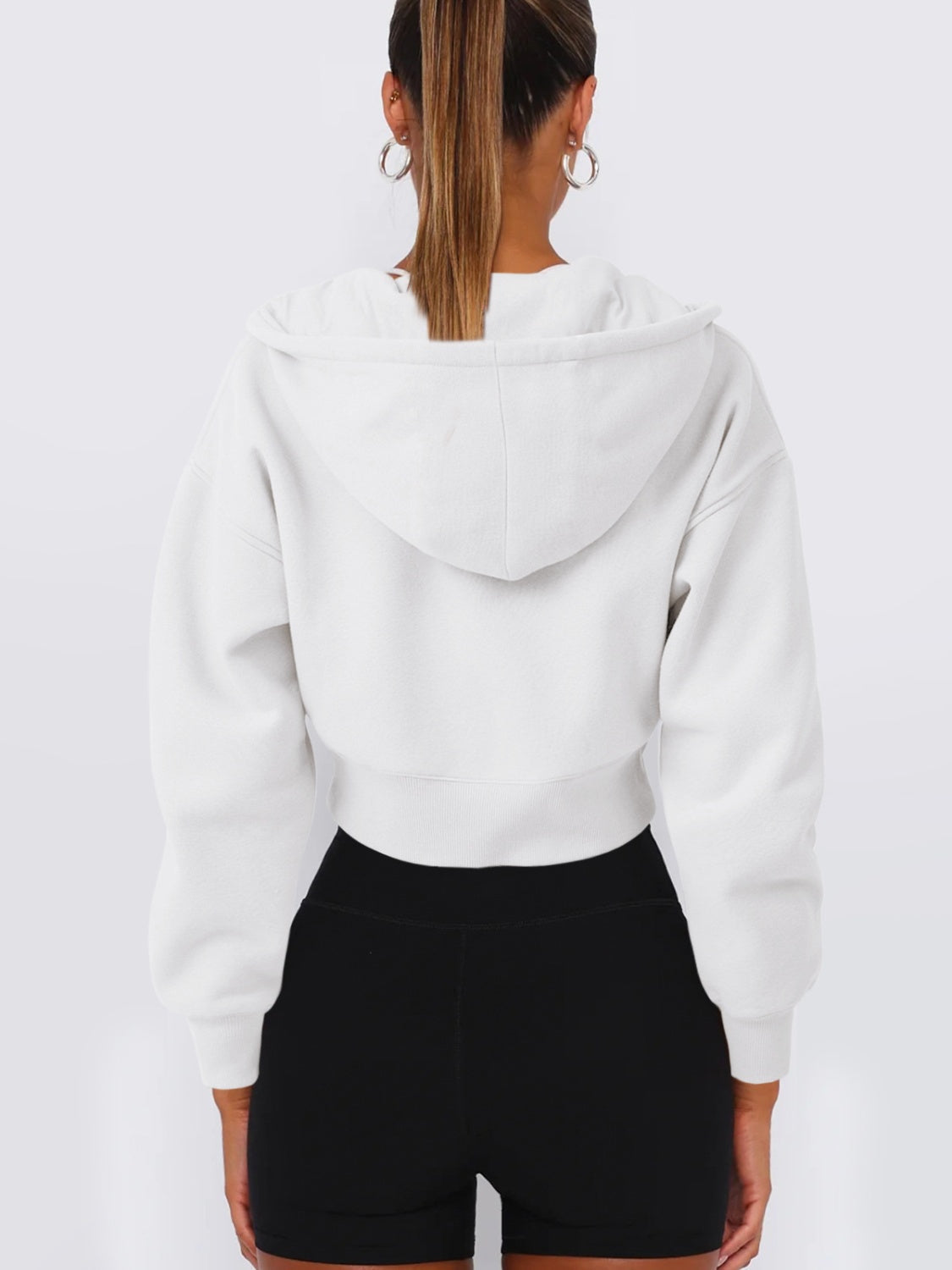 White cropped zip-up hoodie with ribbed hem and hood detail