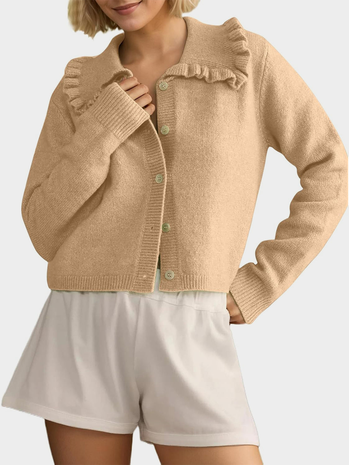 Tan knit cardigan with a frilled collar and button front.