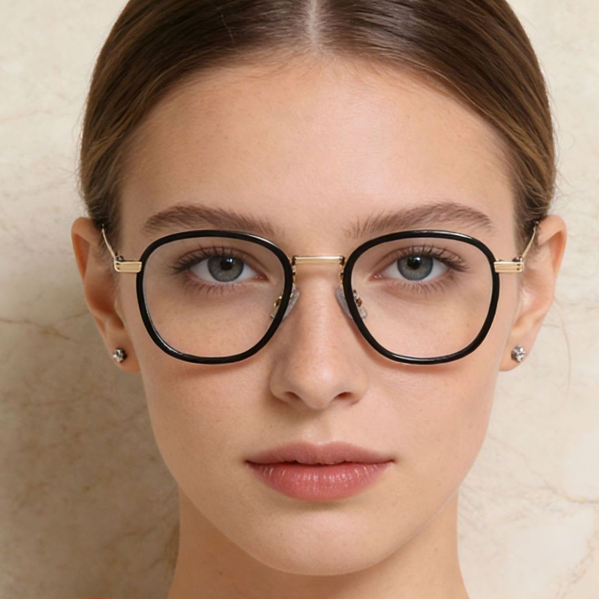 Black round eyeglasses with gold metal temples and clear lenses.