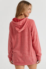 Coral textured raglan sleeve hoodie with a relaxed fit and drawstring hood.