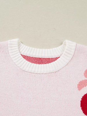 Charming cherry appliqué knit sweater in blush pink with white ribbed crew neck.