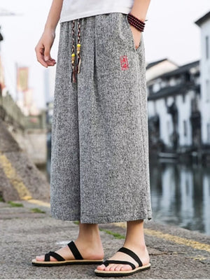 Gray relaxed fit wide-leg casual pants with drawstring and red embroidered detail.