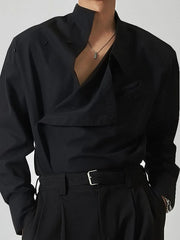 Black asymmetrical button-up shirt with architectural collar and draped detail.