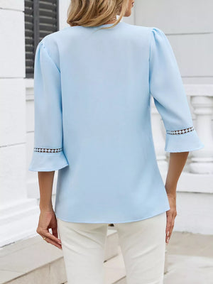 Sky blue blouse with 3/4 sleeves and lace trim cuffs, V-neck detail visible.