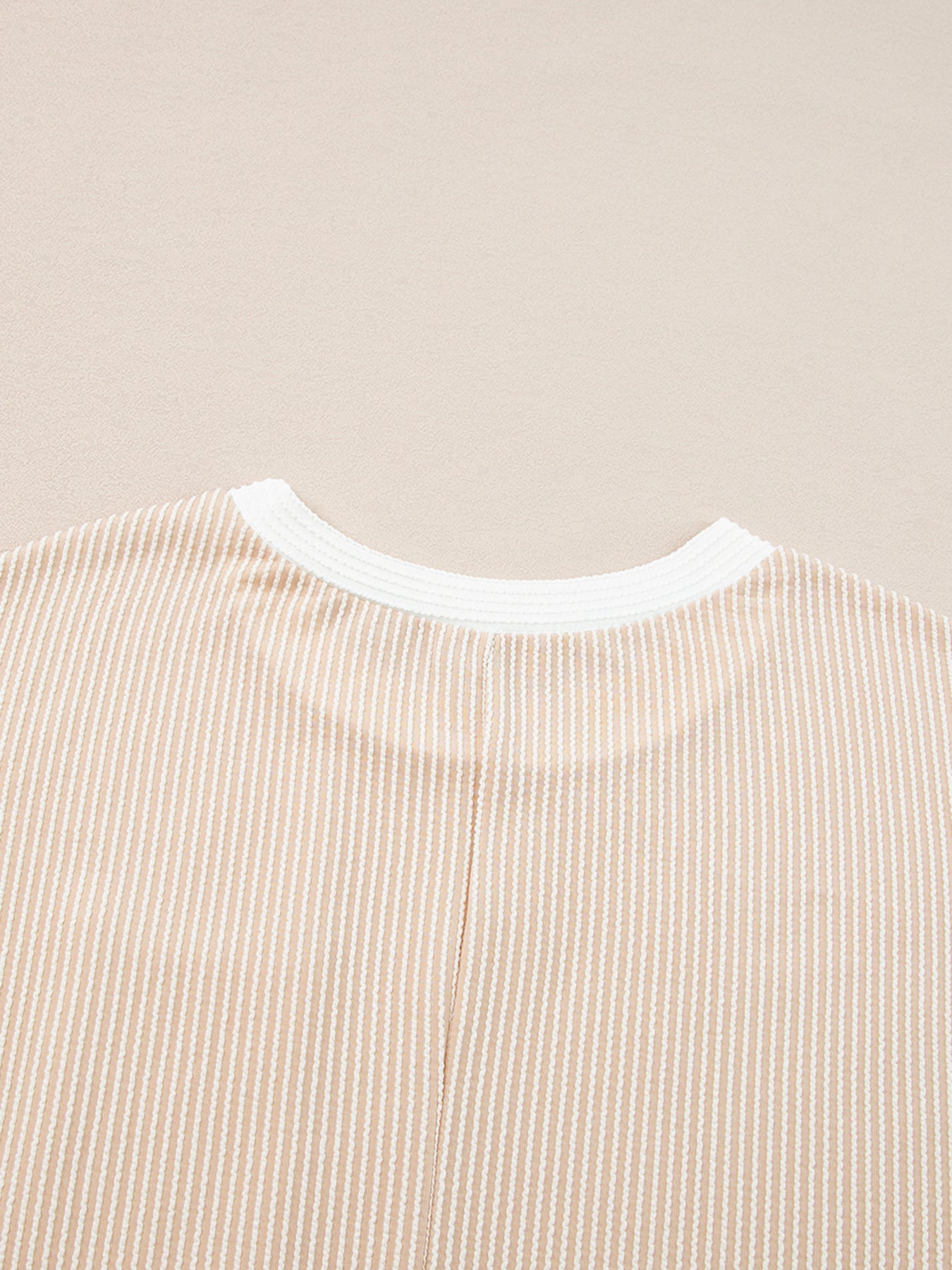 Beige striped t-shirt dress with crew neck and white trim detail.