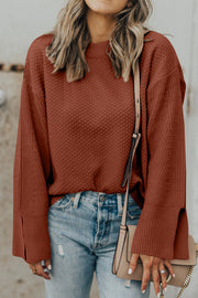Textured knit sweater in ochre with crewneck and slit bell sleeves.