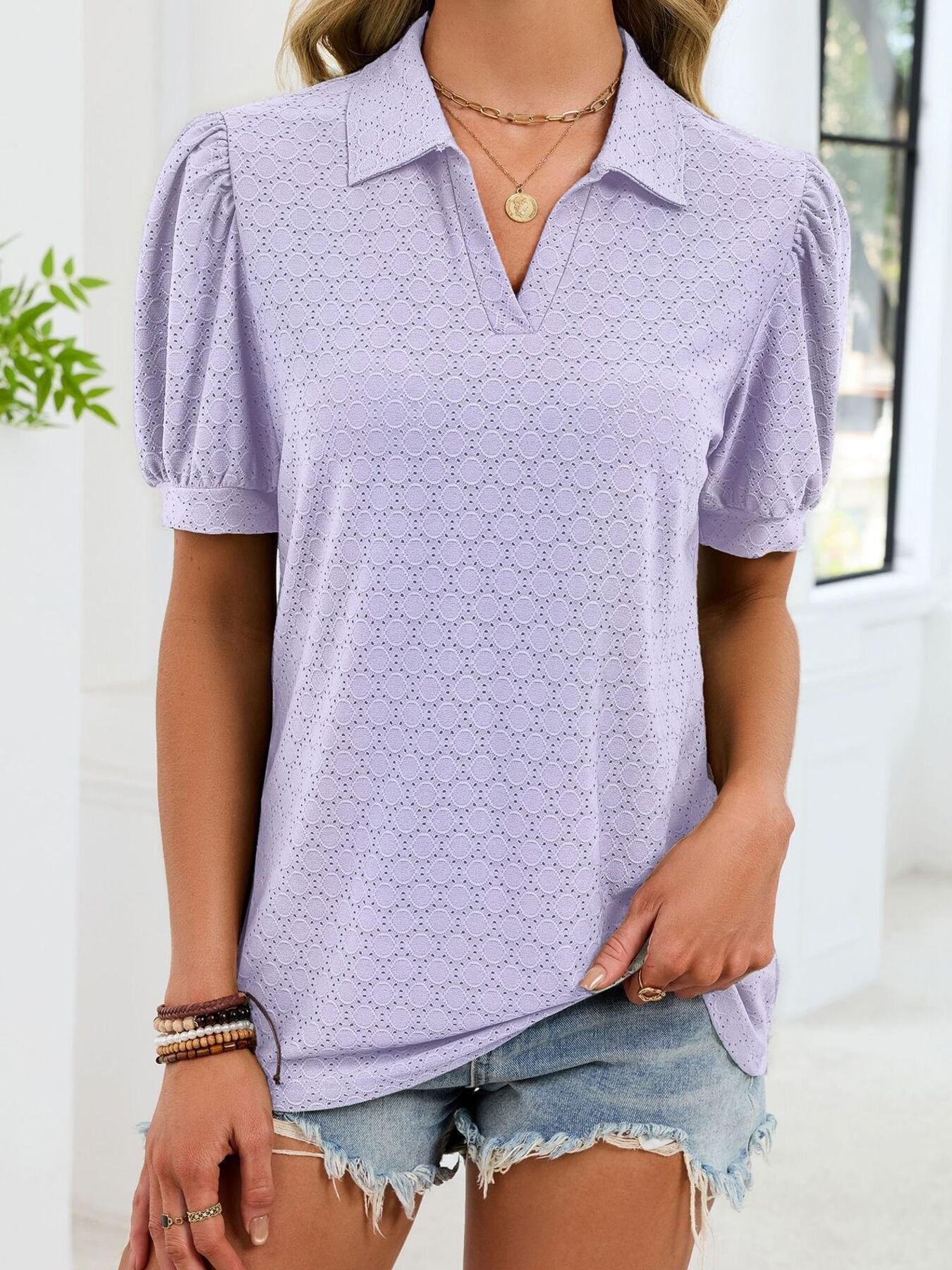 Purple eyelet collar top with puff sleeves and v-neck, styled with denim shorts.