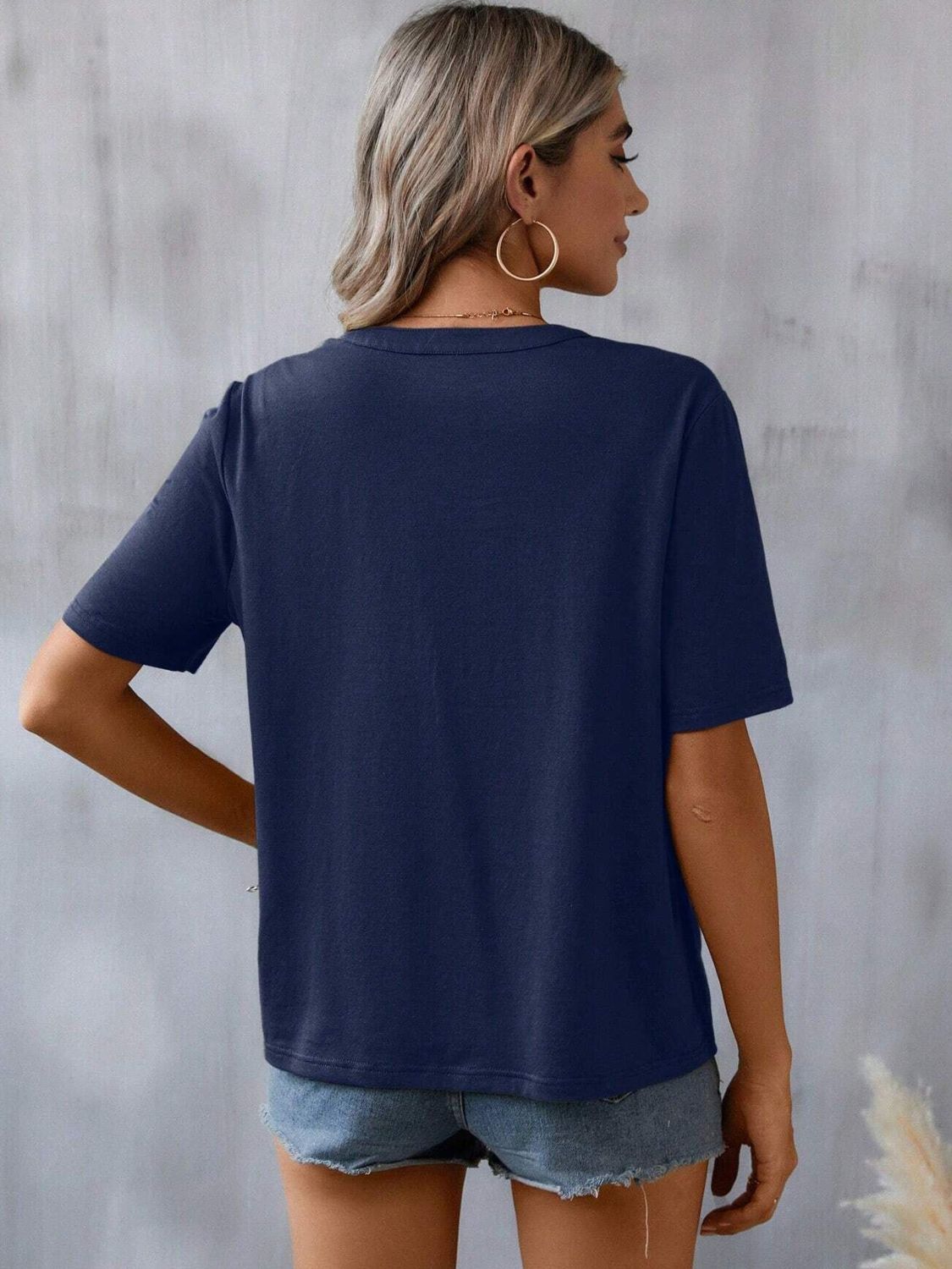 Dark navy V-neck tee with crochet trim detail, short sleeves, casual fit.