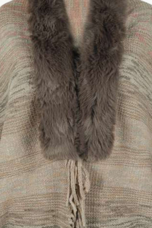 Textured knit cape in tan with faux fur collar and fringe detail
