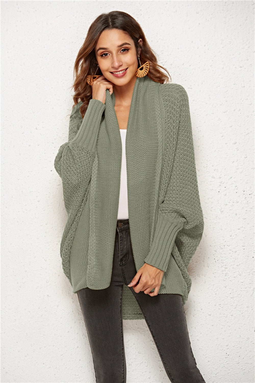 Sage green acrylic knit cardigan with shawl collar and batwing sleeves.