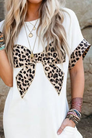 White midi dress with leopard print bow detail and sleeve trim.