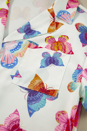 White pajama set with colorful butterfly print and chest pocket.