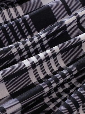 Belted plaid long-sleeve dress in black, close-up of fabric texture