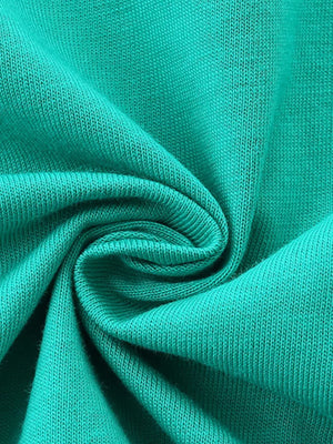Teal cotton t-shirt fabric detail, showing knit texture.