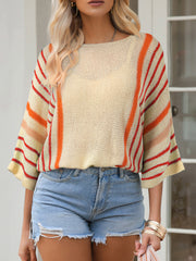 Colorblock sleeve knit pullover with crew neck and striped pattern in cream, orange, and red.