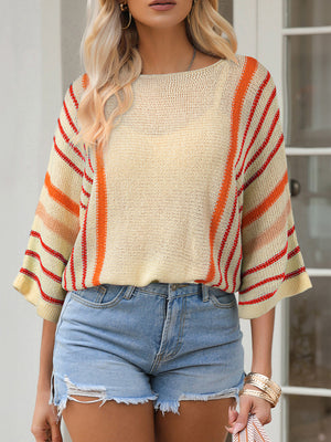 Colorblock sleeve knit pullover with crew neck and striped pattern in cream, orange, and red.