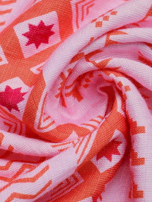 Pink halter neck midi dress fabric with orange geometric pattern and star details.