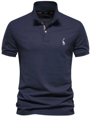 Navy piqué polo shirt with giraffe embroidery and striped collar detail.