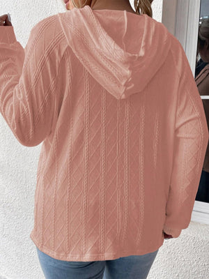 Textured knit raglan hoodie in watermelon pink with diamond and cable knit patterns.