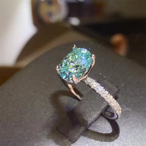 Silver ring with oval aqua moissanite and pavé band