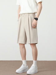 Men's cream chino shorts with pleated details and a loose fit.