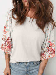 Ribbed white half sleeve top with floral print sleeves and puff details.