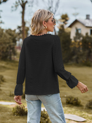 Black textured blouse with lace trim at neckline and cuffs