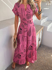 Hot Pink geometric print wide-leg jumpsuit with V-neck and short sleeves.