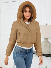 Camel puffer jacket with faux fur trim hood and zippered pockets.