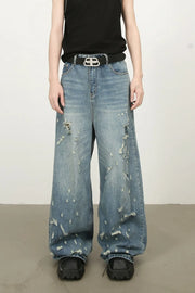 Distressed palazzo jeans in medium wash denim with raw edge detail and wide leg