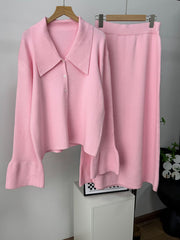 Pink ribbed knit cardigan with collar and flared sleeves, paired with a matching midi skirt.