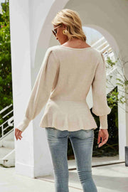 Cream ribbed knit peplum top with puffed sleeves and a flattering fit