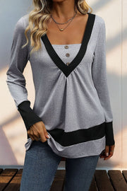 Gray long sleeve top with contrast black V-neck yoke and button detail
