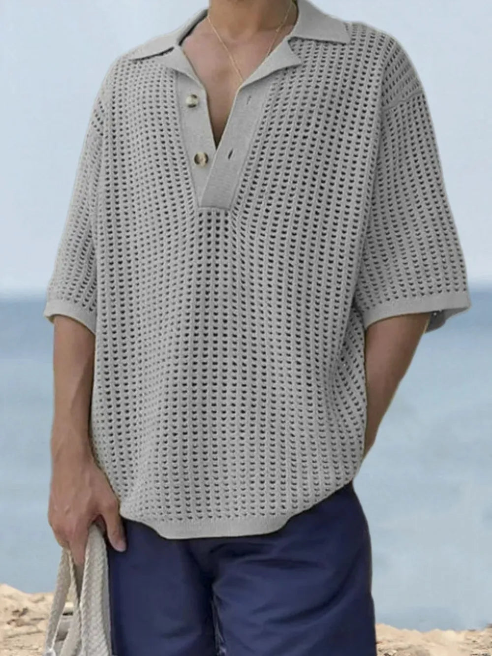 Gray open-knit polo shirt with pointed collar and short sleeves.