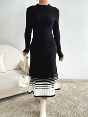 Black ribbed knit midi dress with contrast striped hem and mock neck.