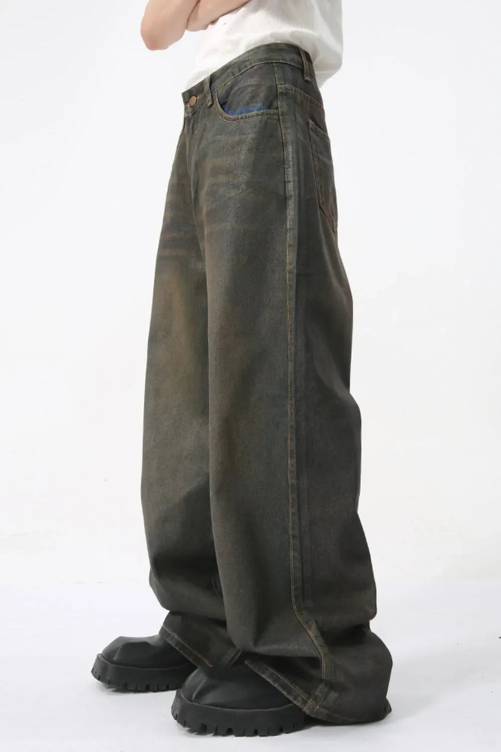Faded oversized denim trousers in dark wash, featuring a relaxed fit and wide leg.