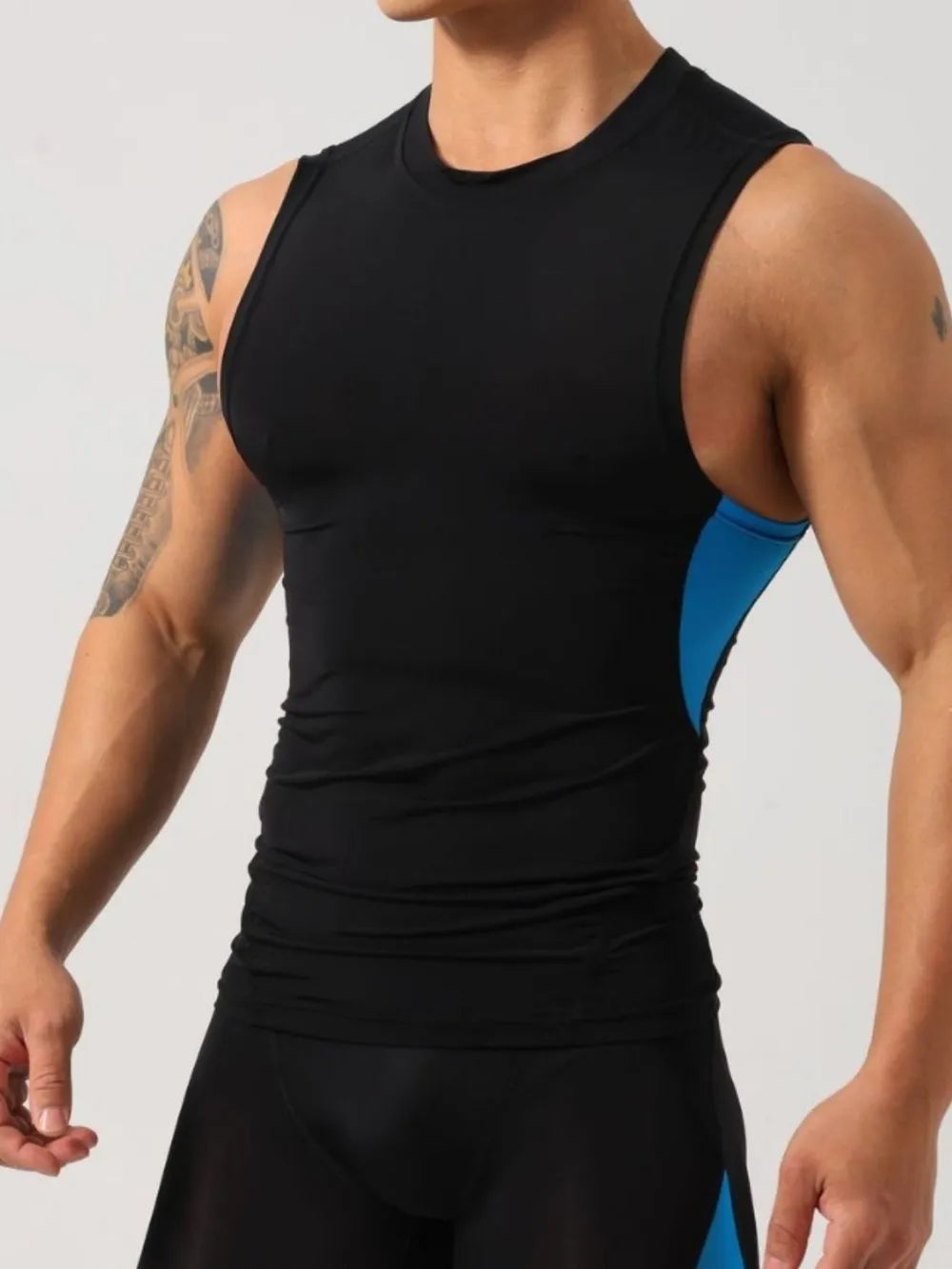 Black performance tank top with sky blue side panels and crew neck.