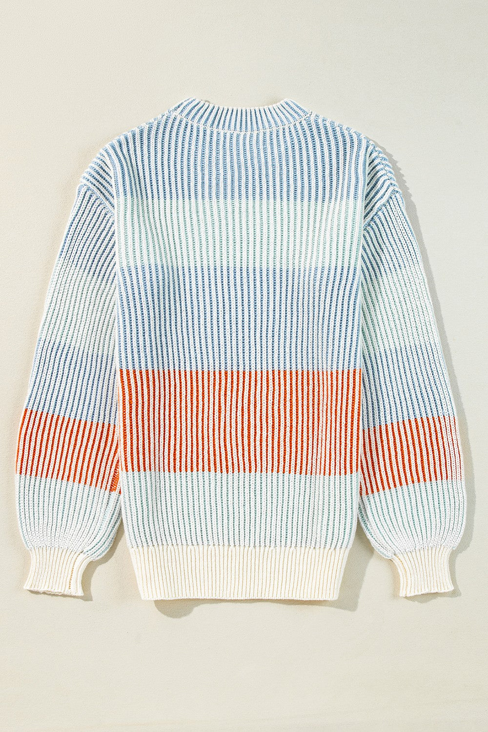 Ribbed stripe knit sweater with balloon sleeves in blue, green, and tan stripes.