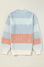 Ribbed stripe knit sweater with balloon sleeves in blue, green, and tan stripes.