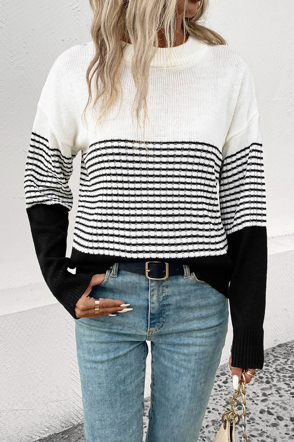 Colorblock stripe crewneck sweater in white and black acrylic with a casual fit.