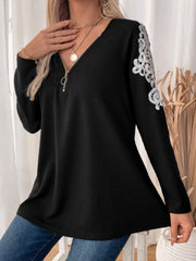 Black ribbed knit zip-front top with white lace trim on the shoulders.