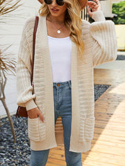 Open knit ivory slouchy cardigan with pockets and balloon sleeves.