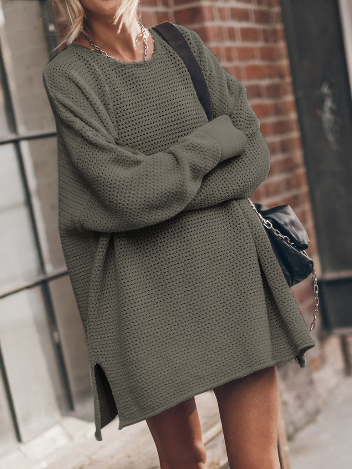 Oversized open-knit sweater dress in army green with crew neck and side slits.