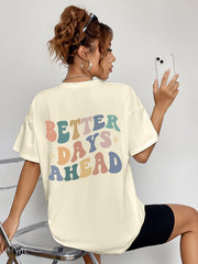 Oversized graphic tee in light yellow with retro "BETTER DAYS AHEAD" text graphic.