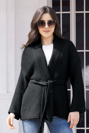 Black waffle knit belted cardigan with shawl collar and long sleeves