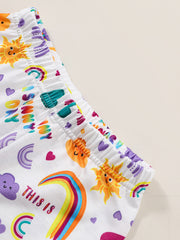 Girls' white graphic tee and shorts set with sun, rainbow, and cloud prints.