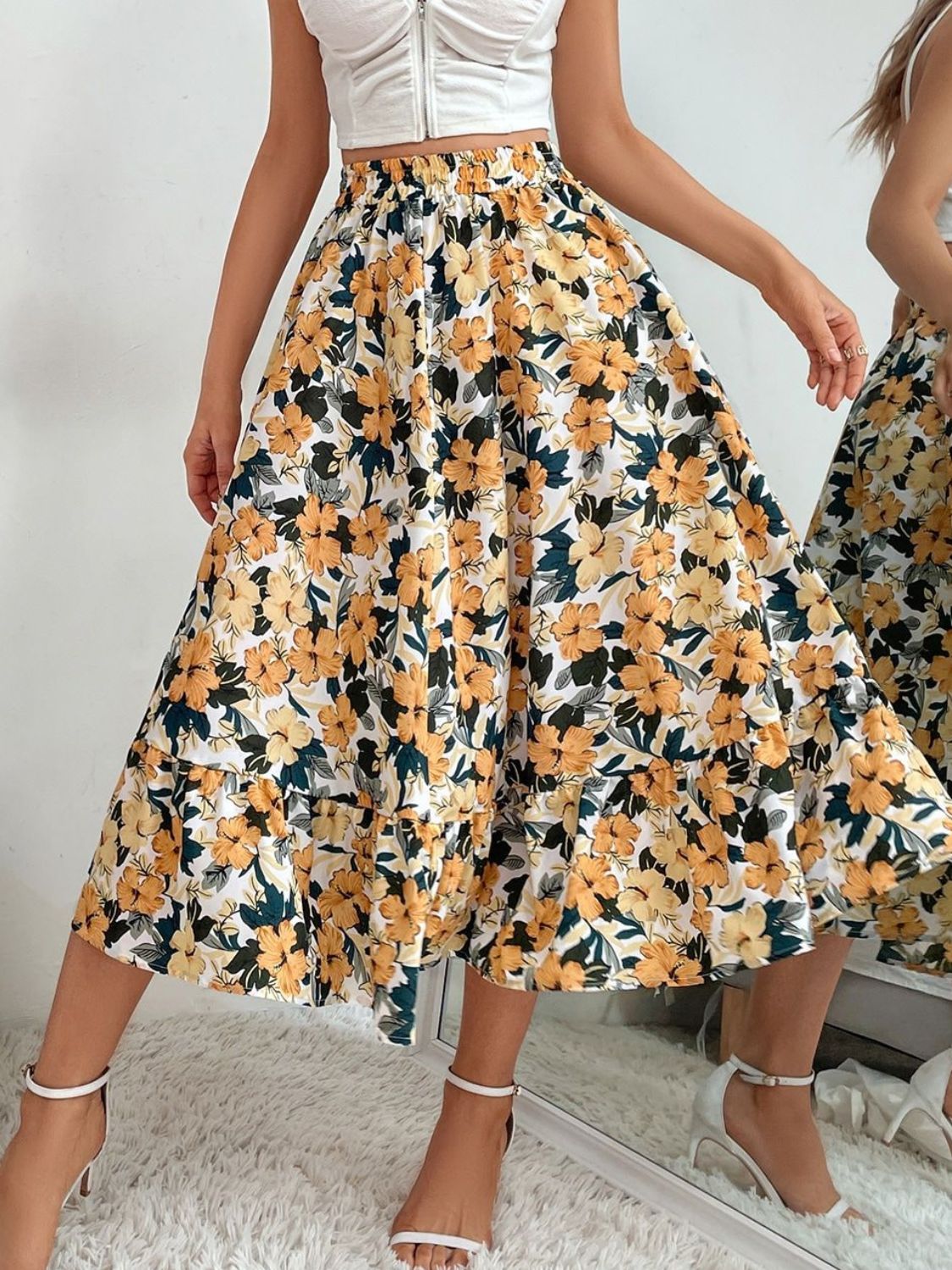 Tiered midi skirt with yellow floral print and smocked waist.