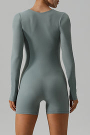 Light green long sleeve unitard with a square neckline and short legs.
